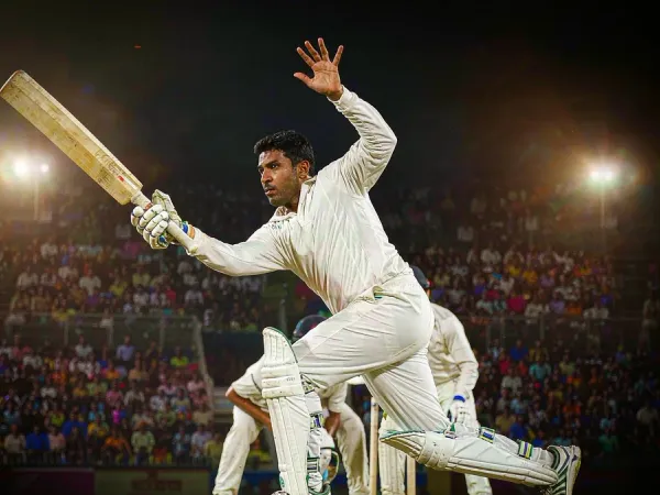 lucky777 Cricketer in white plays a shot under floodlights in a packed stadium at night